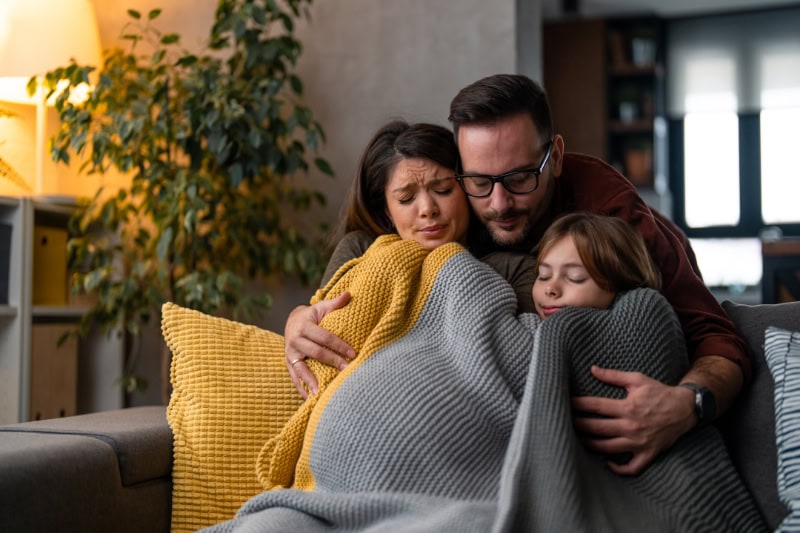 Family of three freezing at home because of the cold temperature due to high energy price.