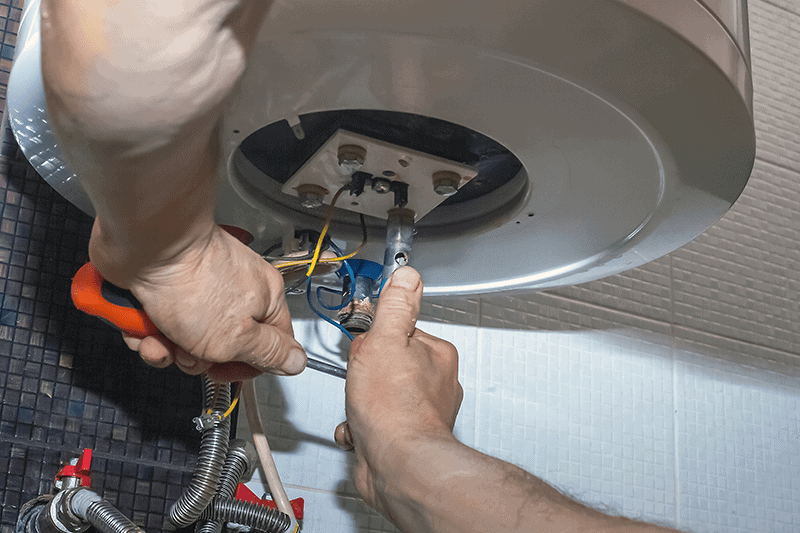 Image of someone working on a furnace. What Are Signs I Need a New Furnace?