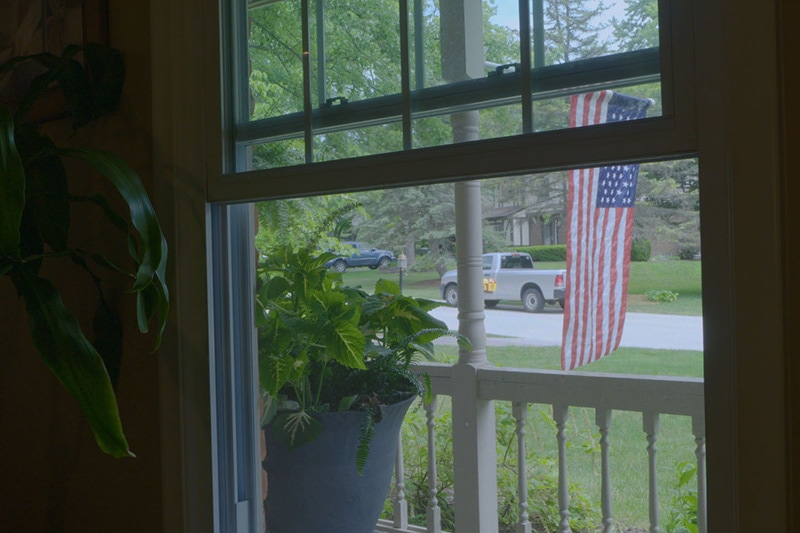 Open window with an American flag outside