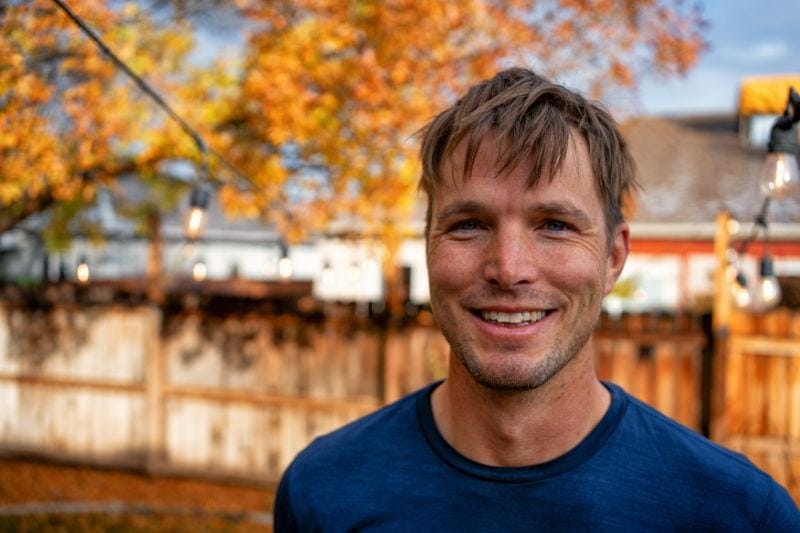 Preparing Your HVAC System for the Fall - Man in front of Fall Backdrop.