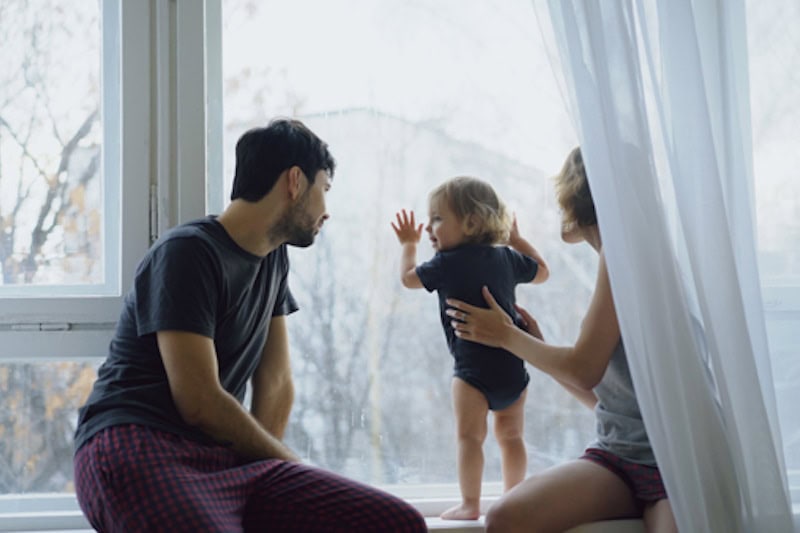 Happy family with young cute daughter sitting on windowsill playing and looking in window at home Reasons for Dirty Air Filters | Indoor Air Quality | Hybrid | Portland